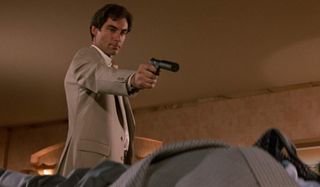 The Living Daylights Timothy Dalton takes aim at a target lying down