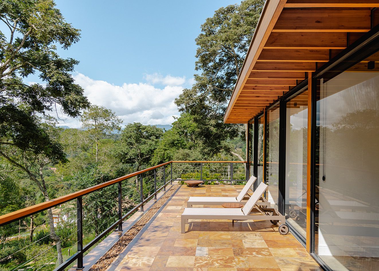 casa pinhal, a house in the woods of brazil, showing here its large terrace looking out