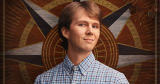 Logan Smith in his casting photo for The Traitors. He's wearing a button-up yellow and blow checkered shirt. 