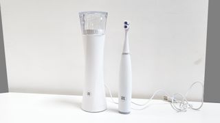 Ultim8 by supermouth toothbrush on white table 