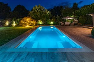 outdoor pool lit up at night by XL Pools