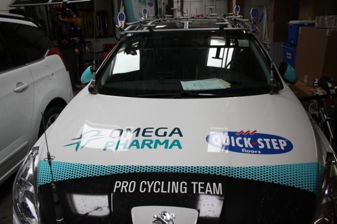 The team cars arrive back after Gent-Wevelgem
