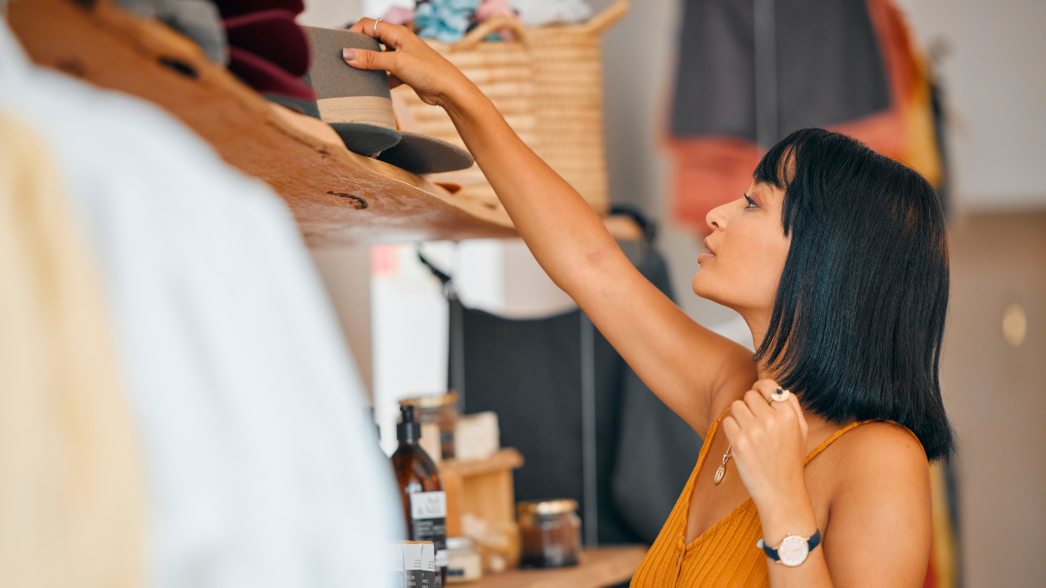 A young woman is shopping at a luxury retail clothing boutique.