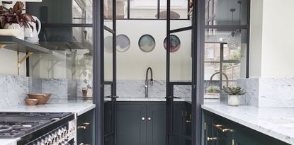 Back kitchen in a blue kitchen with glass doors