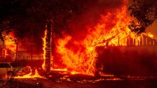 A home is engulfed in flames as the Dixie fire rages on in Greenville, California, on Aug. 5, 2021.