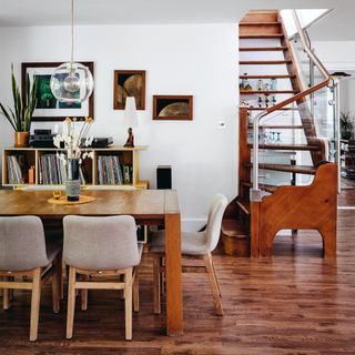 Dining table with chairs leading to stairway
