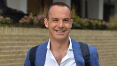 Martin Lewis smiles, wearing a shirt and blazer, as he's seen in London on April 26, 2018