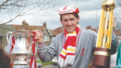 Kenny Dalglish celebrates with two major titles