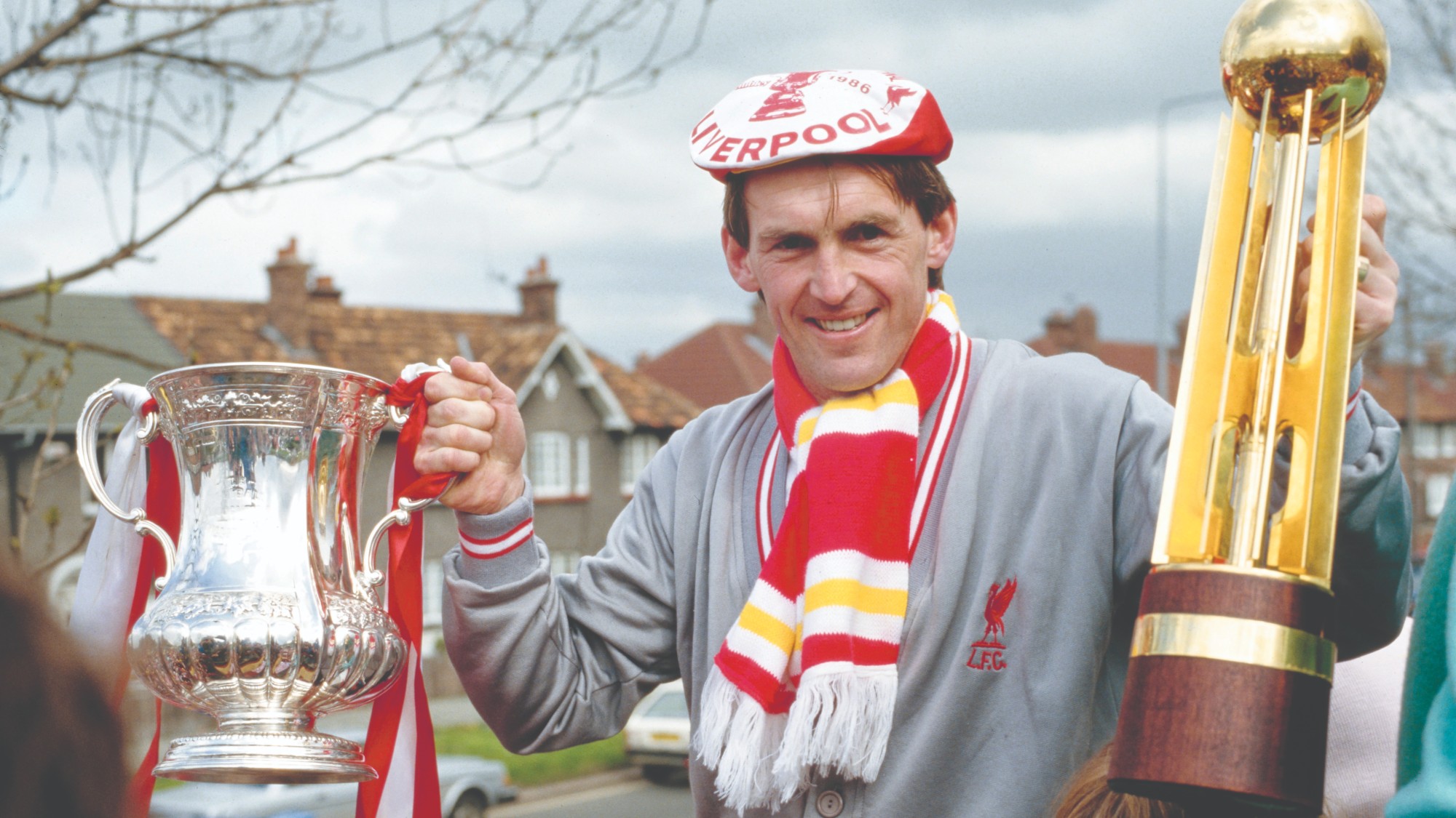 Kenny Dalglish celebrates with two major titles