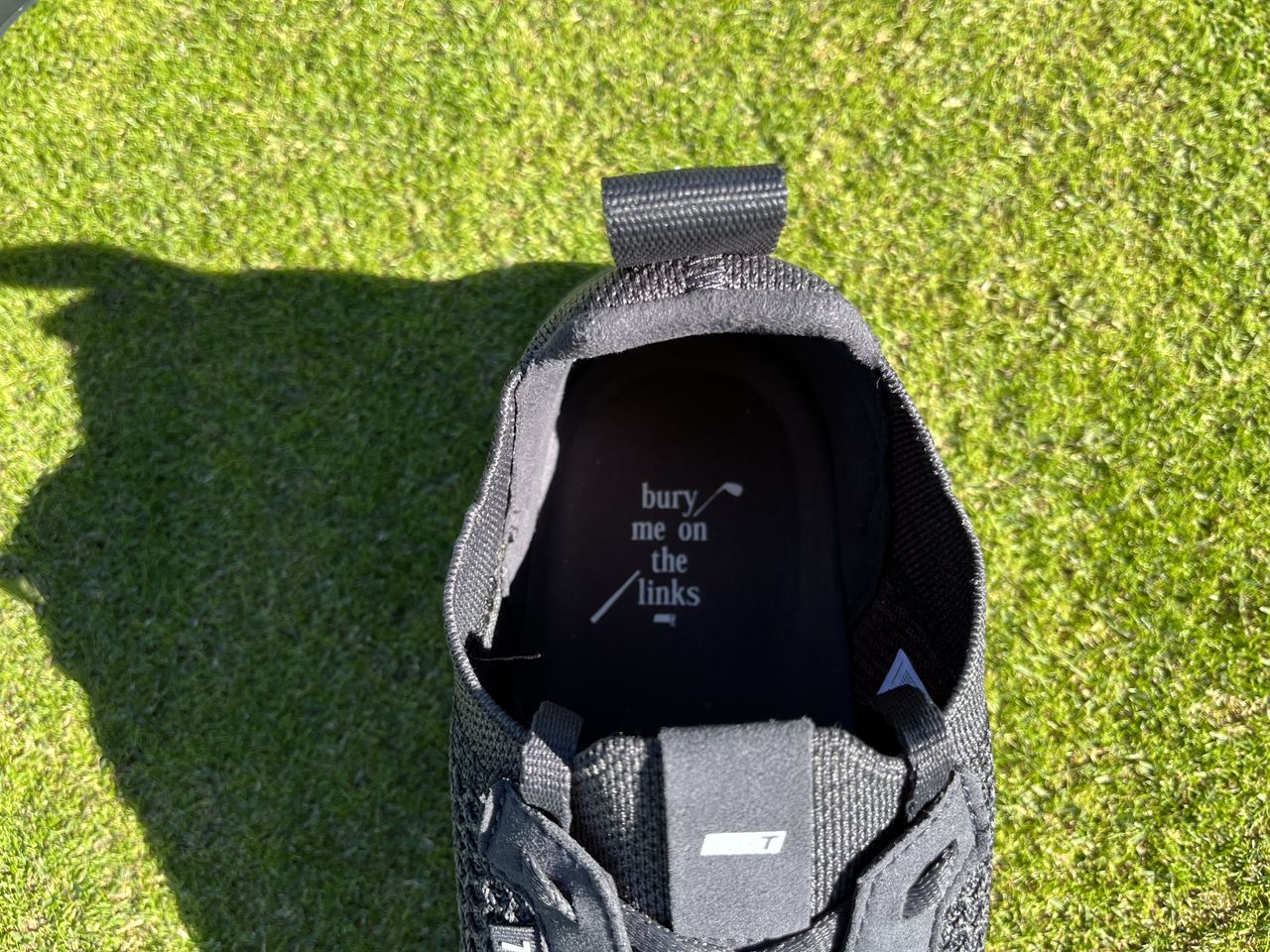 The motif on the insole of the All Day Knit 3 reads 'bury me on the links'