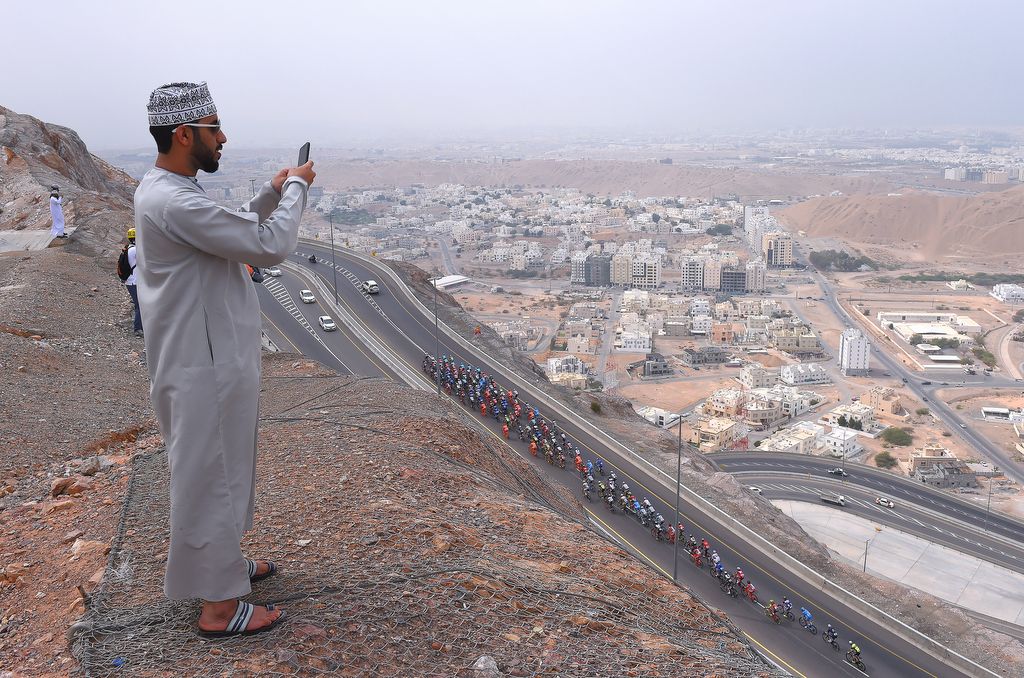 A fan makes sure to get a photo of the peloton