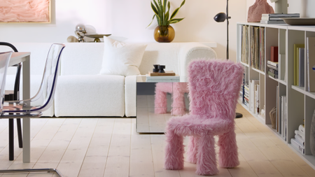 Modern living room featuring a white sofa, chrome side table, and furry pink accent chair