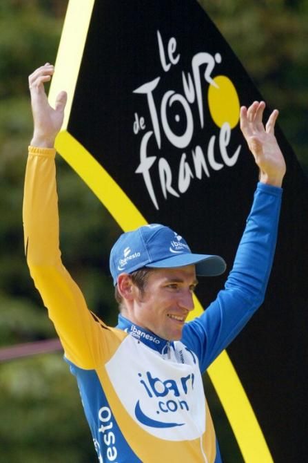 Denis Menchov won the best young rider's classification at the 2003 Tour de France and is on the podium to receive his final white jersey