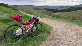 Gravel bike by track and landscape beyond