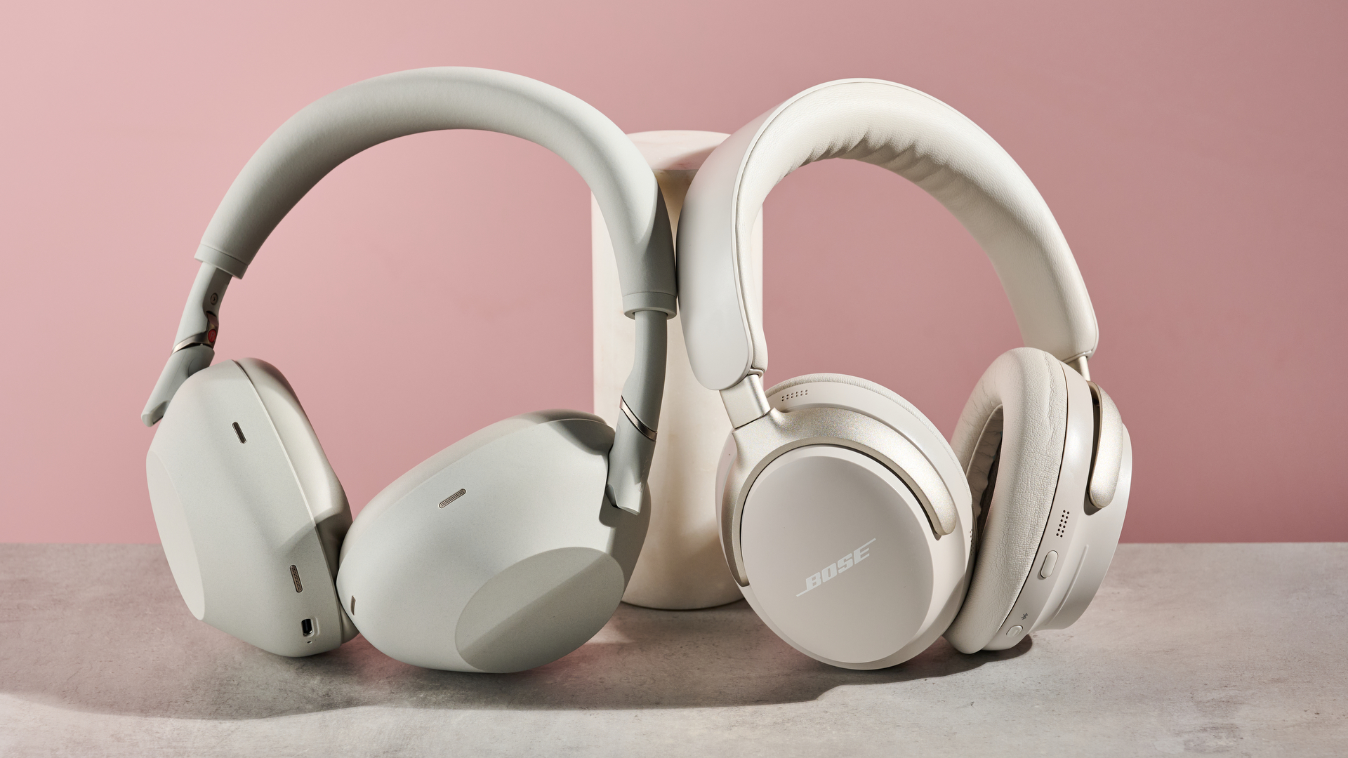 Sony WH-1000XM6 and Bose QuietComfort Ultra leaning on pole