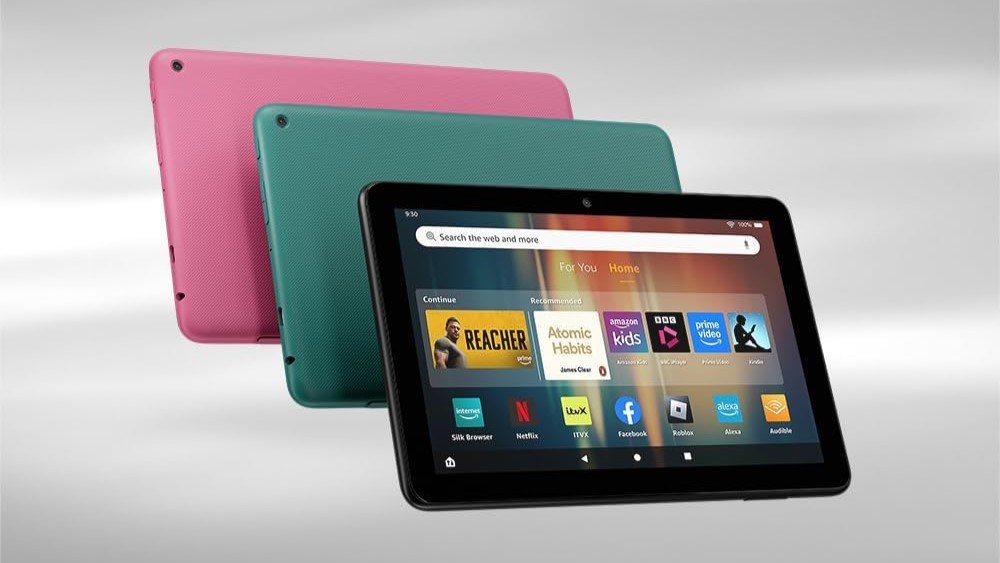 Three Amazon Fire HD 8 (2024) tablets, one in pink, one in green floating in front of it, and a black one showing a screen in front of them both.