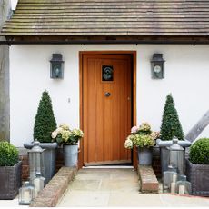 exterior of house with white walls wooden door and clay roof tiles