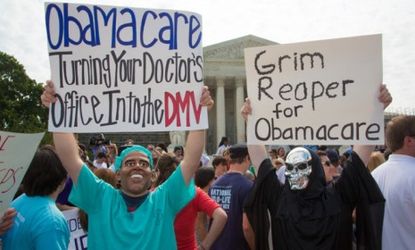 Anti-ObamaCare demonstrators protest the SupremeCourt's ruling Thursday