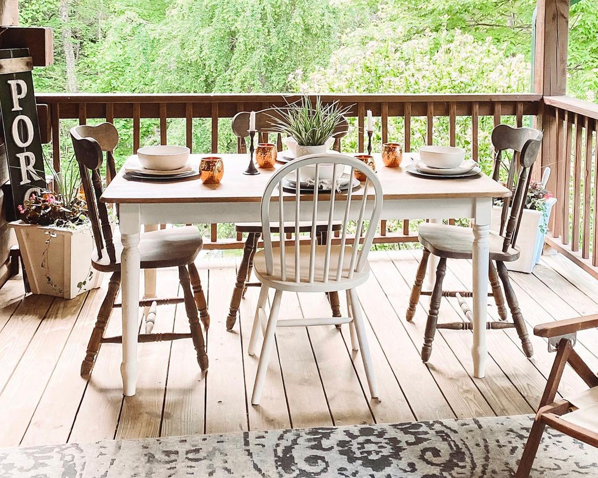 Porch with wooden dining table and chairs, porch sign and plant - @mistymorning_