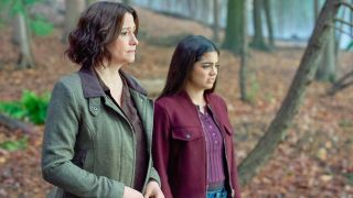 Chyler Leigh and Sadie Laflamme-Snow both wearing fall appropriate jackets and contemplating jumping in the pond.