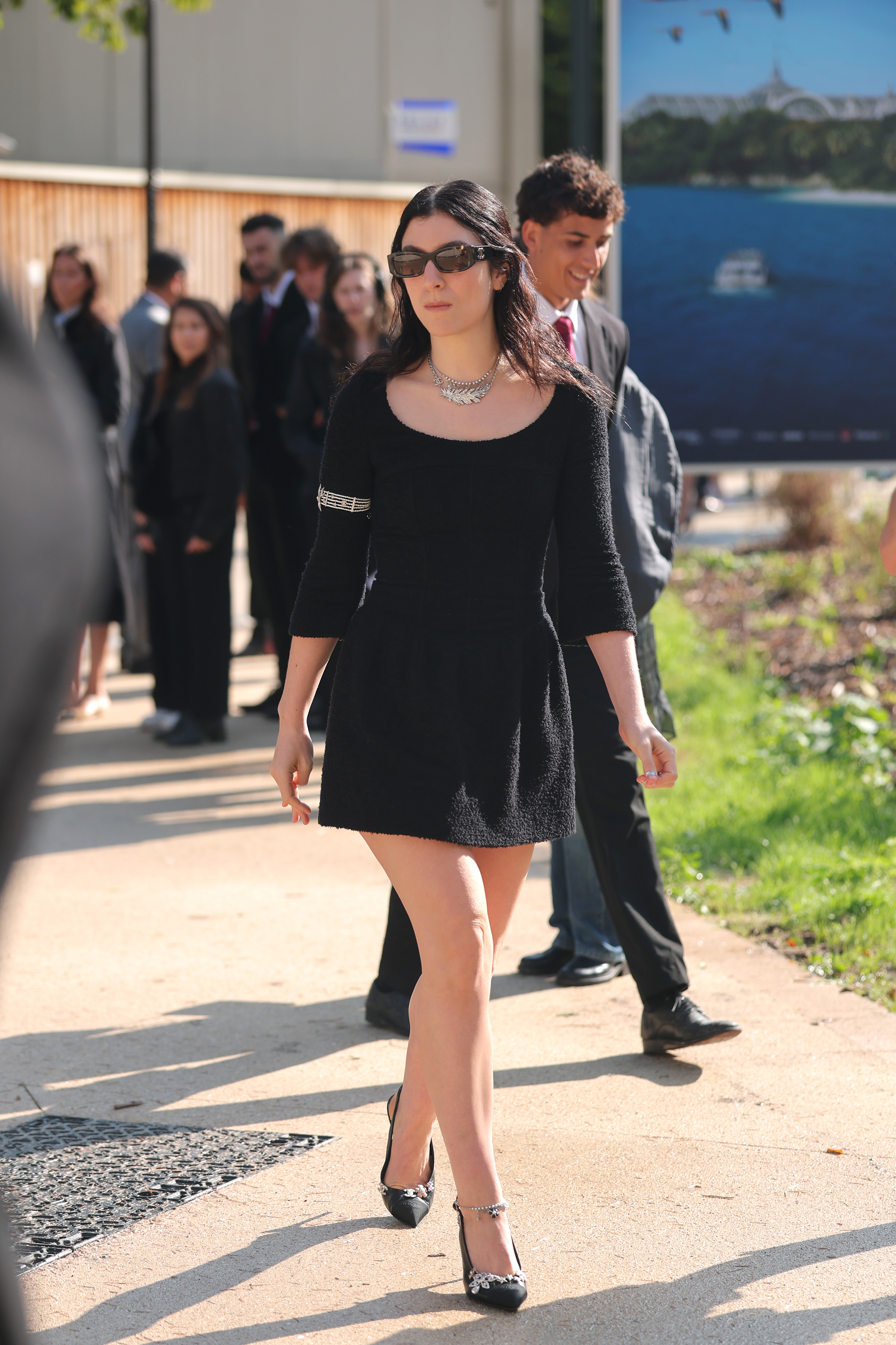 Lorde wears a black dress and slingbacks to the Chanel show.