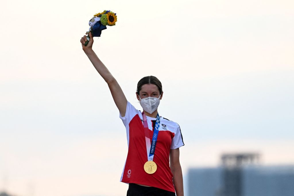 Gold medallist Austrias Anna Kiesenhofer celebrates on the podium during the medal ceremony for the womens cycling road race of the Tokyo 2020 Olympic Games at the Fuji International Speedway in Oyama Japan on July 25 2021 Photo by Greg Baker AFP Photo by GREG BAKERAFP via Getty Images