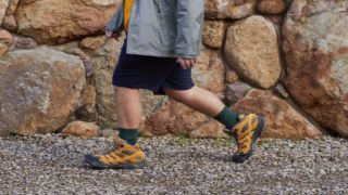 A man walking wearing Merrell walking boots