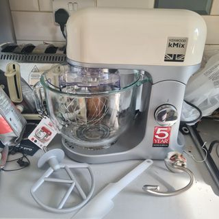 Kenwood kMix mixer and accessories in cream on kitchen counter