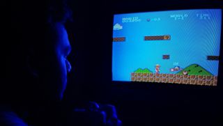 Photo of Man Playing Super Mario Bros