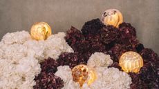 hand-formed glass lamps arranged in floral displays