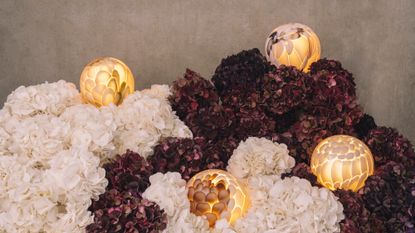 hand-formed glass lamps arranged in floral displays