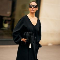 fashion week attendee wearing sunglasses, black v-neck sweater