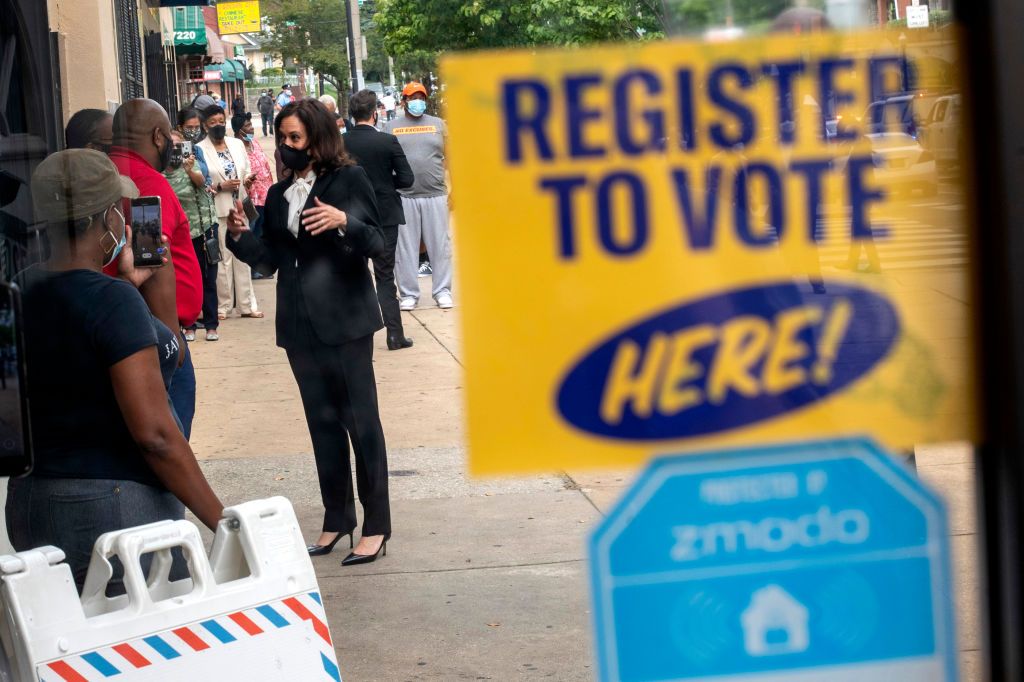 Sen. Kamala Harris talks to people registering to vote.