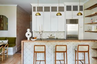 a small kitchen with a tiled breakfast bar