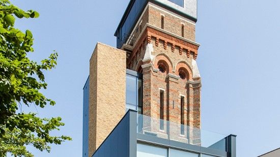 multistoried building with glass windows and trees