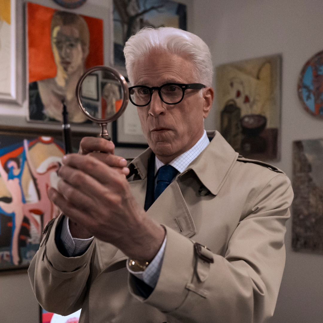 ted danson as charles in a trench coat holding up a magnifying glass in a man on the inside season 2