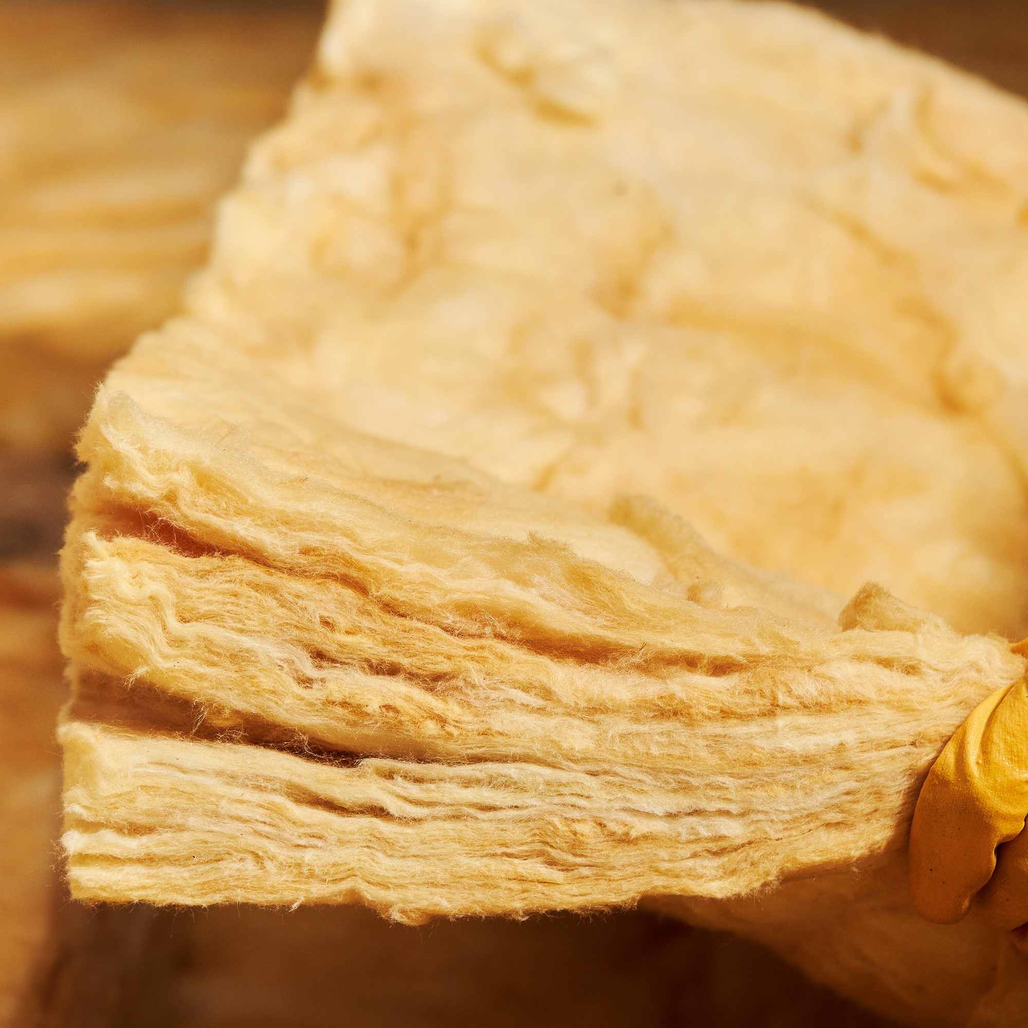Close up of mineral wool insulation being installed in a loft