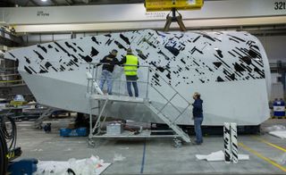 Artwork being applied to the turbine in a workshop