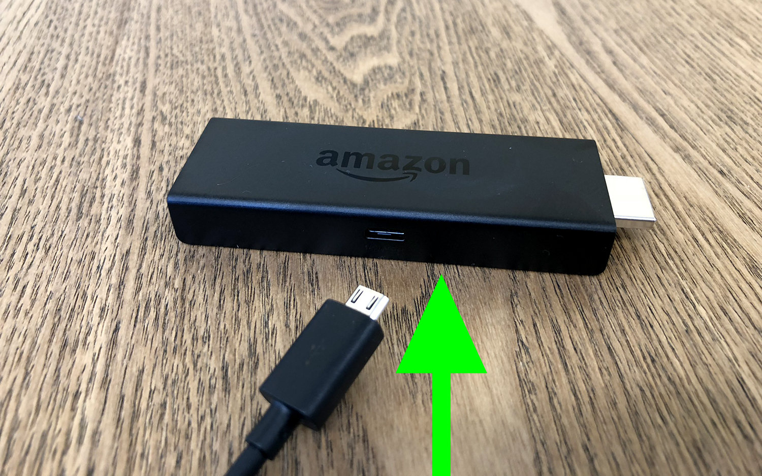 The Fire TV Stick and the USB power cord going into it