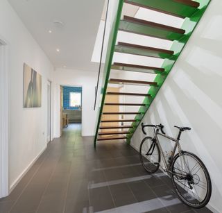 Green stairs in hallway designed by Van Ellen + Sheryn Architects