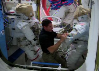 Mike Hopkins Works with Spacesuits in Quest Airlock