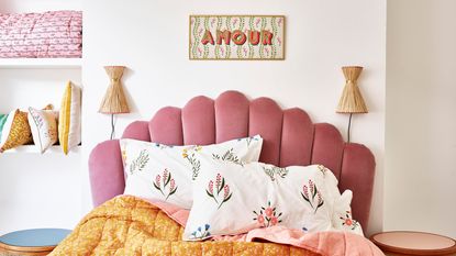A bedroom wall lighting idea by Oliver Bonas using a pair of Alohi Raffia Wall Light £49.50, with pink scalloped headboard