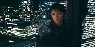 daisy ridley scales the outside of a building while punching a hole through the window's glass in the movie cleaner