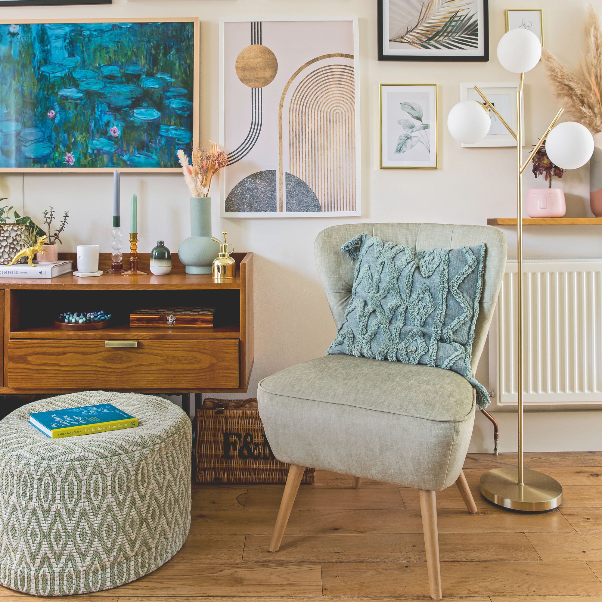 Accent chair next to a storage unit, in front of a gallery wall