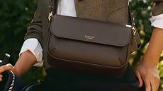 A close up of a rich, brown satchel from Aspinal of London