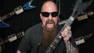 Kerry King holding a guitar and shouting