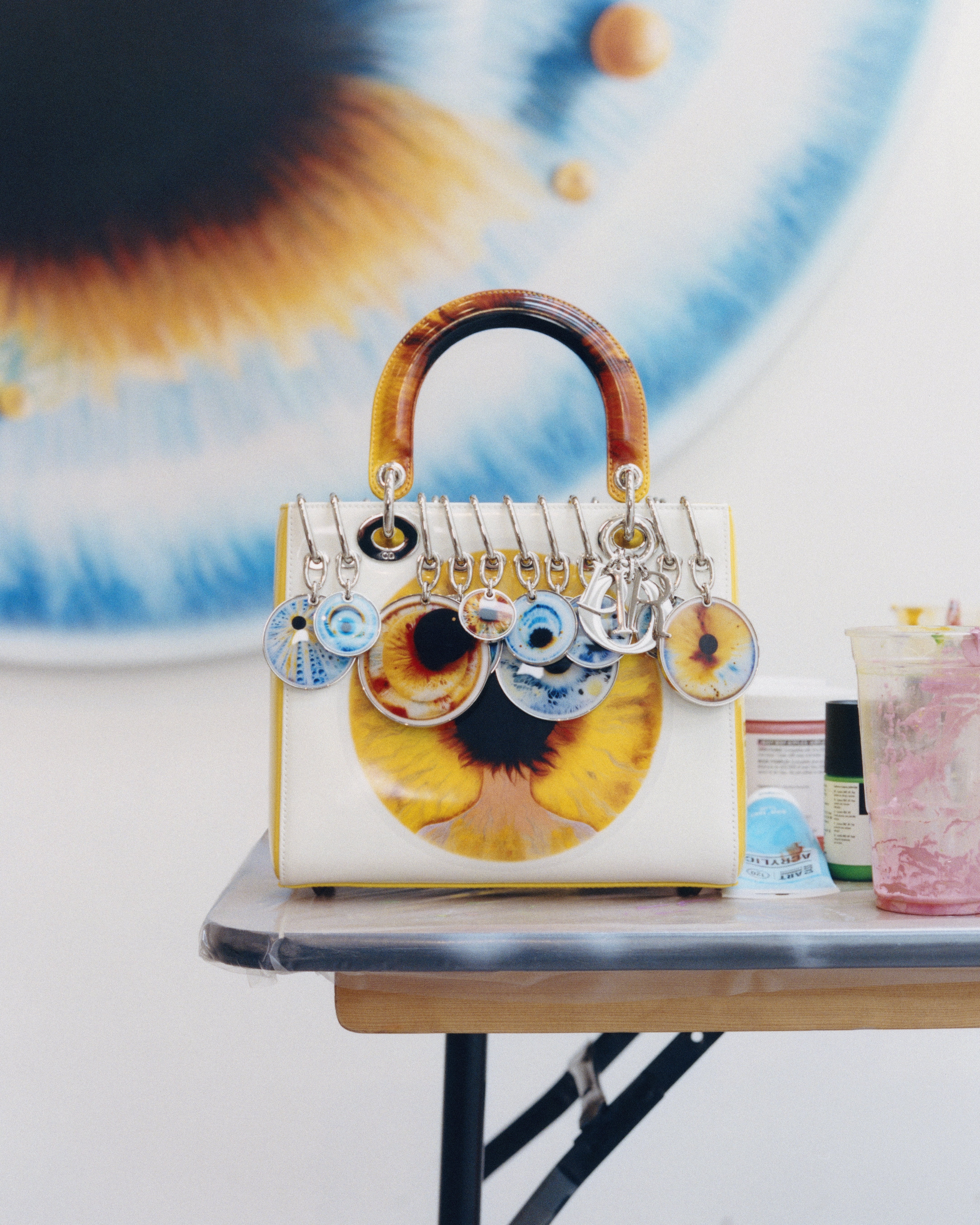 a lady dior art bag with an eye painted on its side