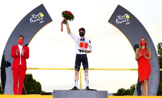 PARIS FRANCE SEPTEMBER 20 Podium Marc Hirschi of Switzerland and Team Sunweb Most Combative Rider Celebration Trophy Flowers Miss Hostess Mask Covid safety measures during the 107th Tour de France 2020 Stage 21 a 122km stage from MantesLaJolie to Paris Champslyses TDF2020 LeTour on September 20 2020 in Paris France Photo by Michael SteeleGetty Images