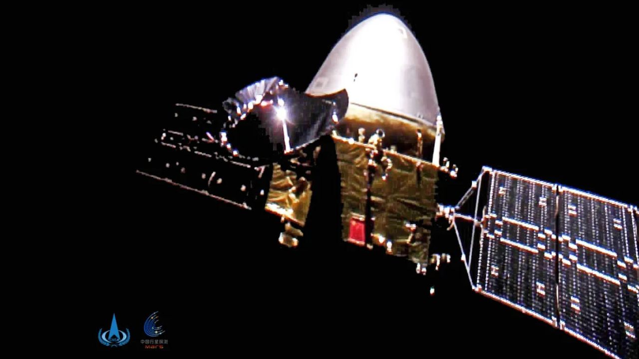 China's Tianwen-1 Mars probe is seen by a tiny camera ejected from the spacecraft in a photo captured 15 million miles from Earth.