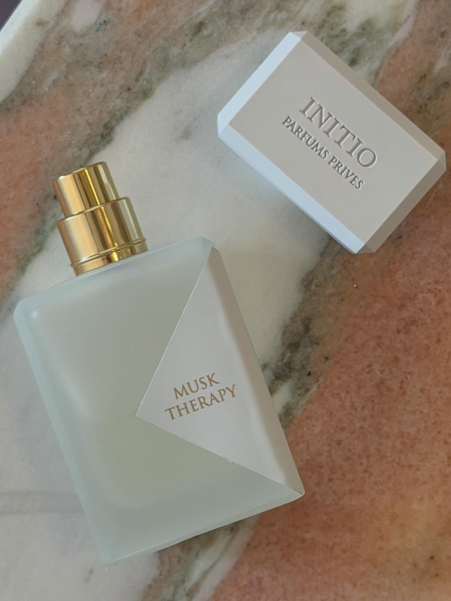 A picture of the Initio Parfums Privés Musk Therapy Hair Mist on a marble table